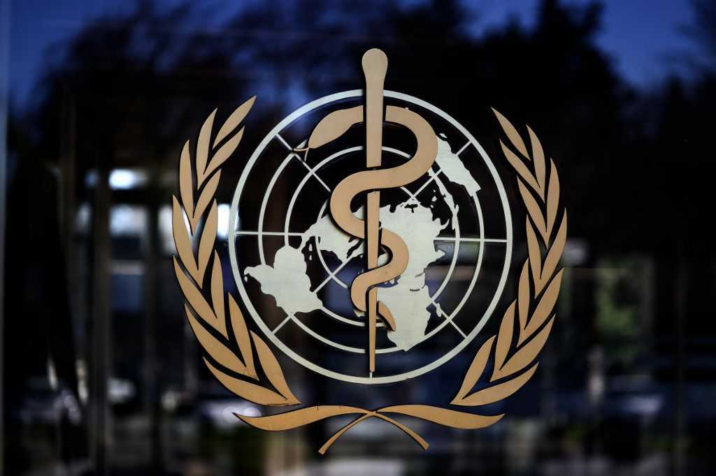 A photo taken on February 24, 2020, shows the logo of the World Health Organization (WHO) at the entrance of their headquarters in Geneva. (Photo by Fabrice COFFRINI / AFP)