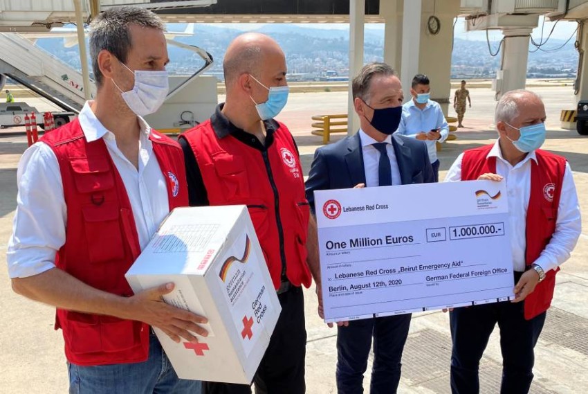 German Foreign Minister Heiko Maas holds a "One Million Euros" cheque for the Lebanese Red Cross "Beirut Emergency Aid" upon his arrival in Beirut, Lebanon, August 12, 2020.     REUTERS/Andreas Rinke