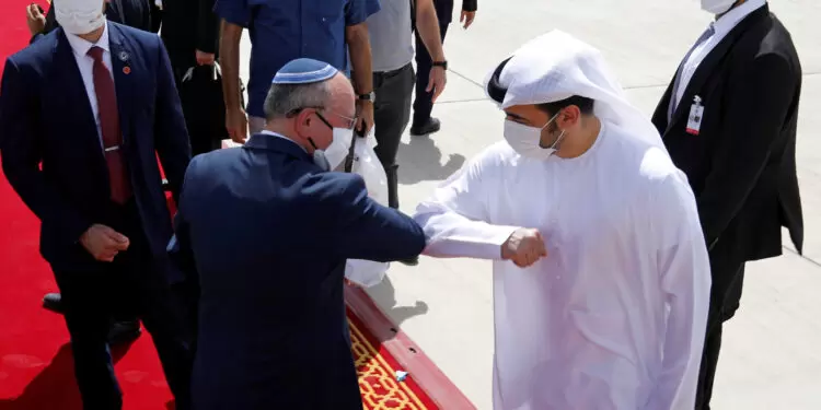 Israeli National Security Advisor Meir Ben-Shabbat elbow bumps with an Emirati official as he makes his way to board the plane to leave Abu Dhabi, United Arab Emirates September 1, 2020. REUTERS/Nir Elias/Pool