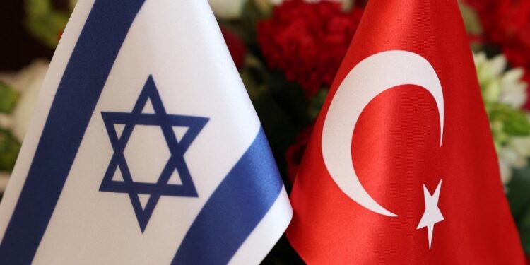 The Turkish (R) and Israeli flags are pictured before a meeting between the Turkish Foreign Minister Mevlut Cavusoglu and Israeli businessmen, in the coastral city of Tel Aviv, on May 25, 2022. - Cavusoglu is on a visit to Israel and the occupied-West Bank to meet with Israeli and Palestinian officials. (Photo by JACK GUEZ / AFP)